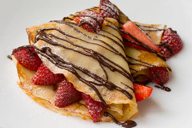 istock Pancakes with strawberries, topped  chocolate.White background. Top view 636118226