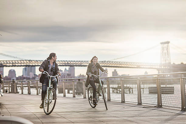 istock Couple riding bicycles against Williamsburg Bridge 636118848