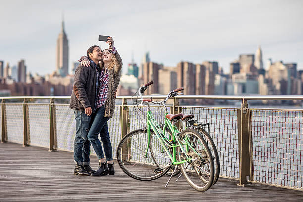 istock Couple taking selfie against Empire State Building 636118858