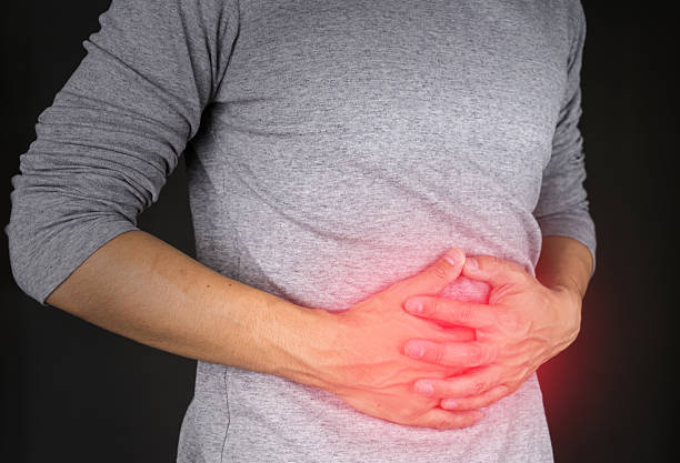 istock man in gray shirt stomachache 636119260