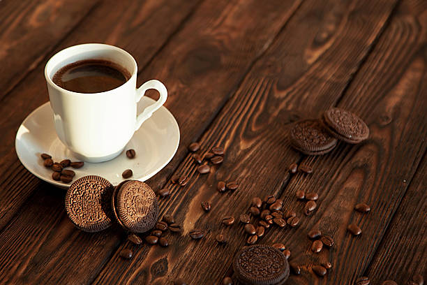 hot coffee and cookies on a wooden table in the sunrise