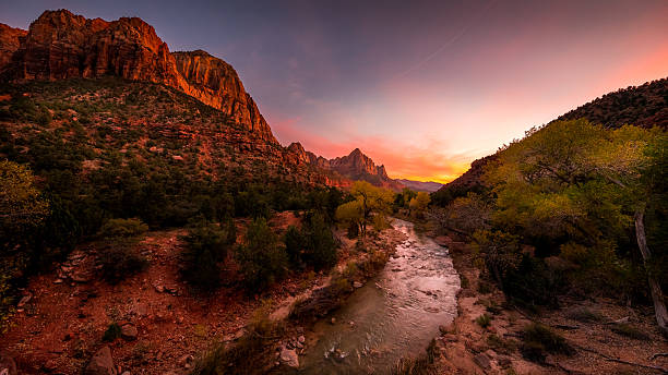 istock The rays of the sun illuminate red cliffs and river. 636119562