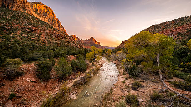 istock The rays of the sun illuminate red cliffs and river. 636119718