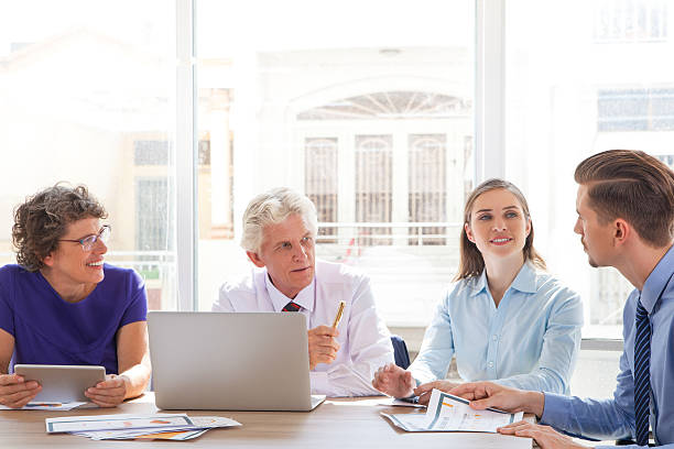 istock Group of four people discussing business issues 636120512