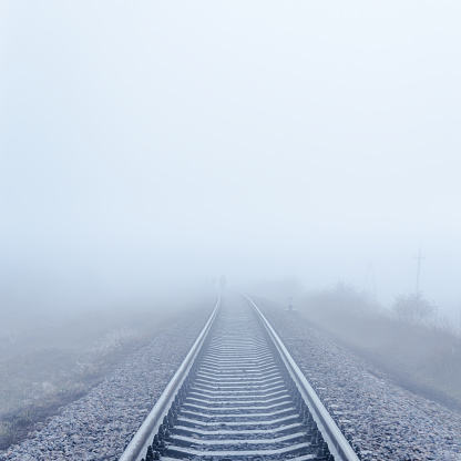 railway to horizon in fog