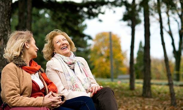 istock Two senior friends laughing at the park. 636121946