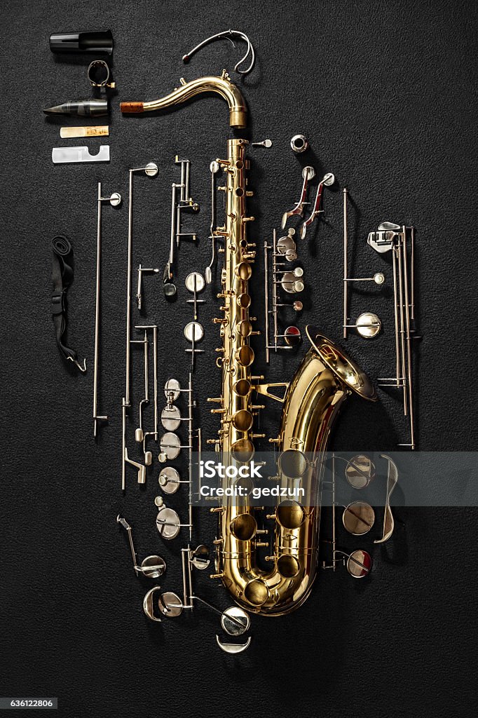 Tenor saxophone, exploded view drawing. Tenor saxophone, exploded view drawing isolated on gray background. Diagram Stock Photo