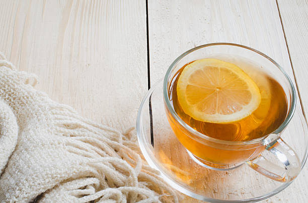 istock Cozy and soft winter background. Tea and warm knitted blanket. 636123878