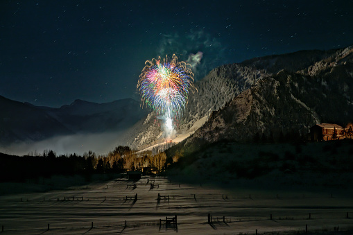 Aspen lit up with the New Years Eve fireworks going off on spin Mountain