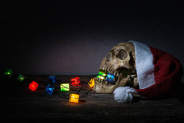 istock Skull wear santaclaus hat with gift blinker light. 636135292