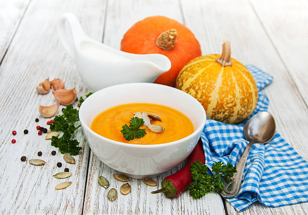 istock Pumpkin soup with fresh pumpkins 636135894