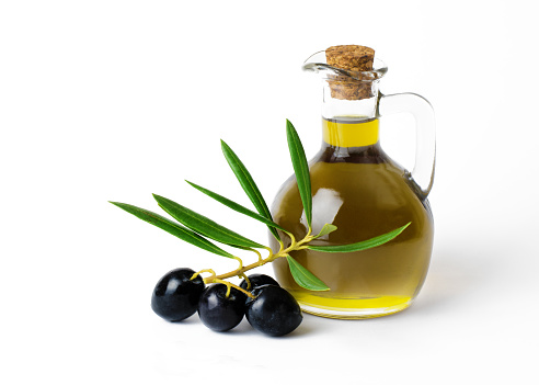 Fresh Organic Olive Oil  with bunch of olives and greenery  on a isolated on a white background