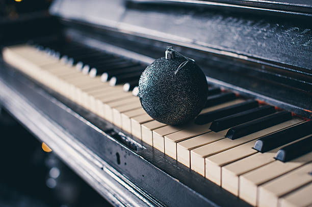 istock Blue Christmas ball on a piano keyboard 636139912