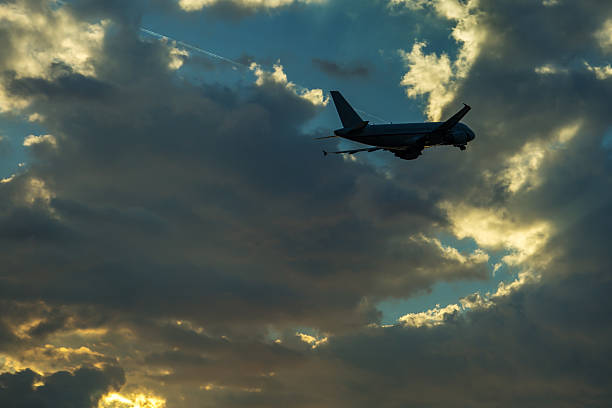 istock Passenger airplane flying in the sky at sunset 636140514