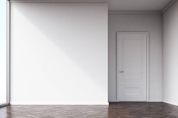 istock Empty room with white walls and dark wood floor 636141052