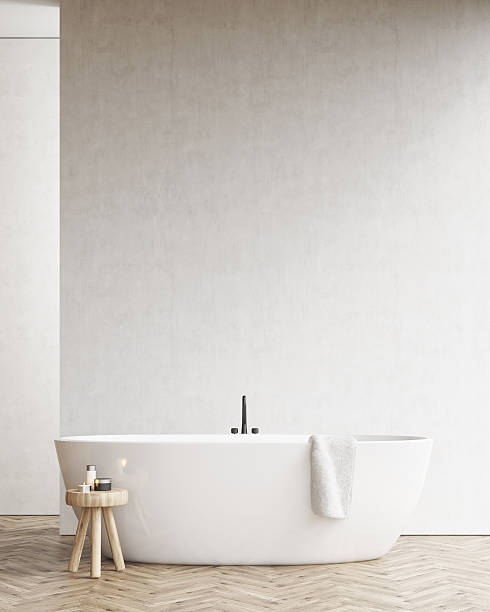 istock Bathtub with a chair and a white wall 636145994