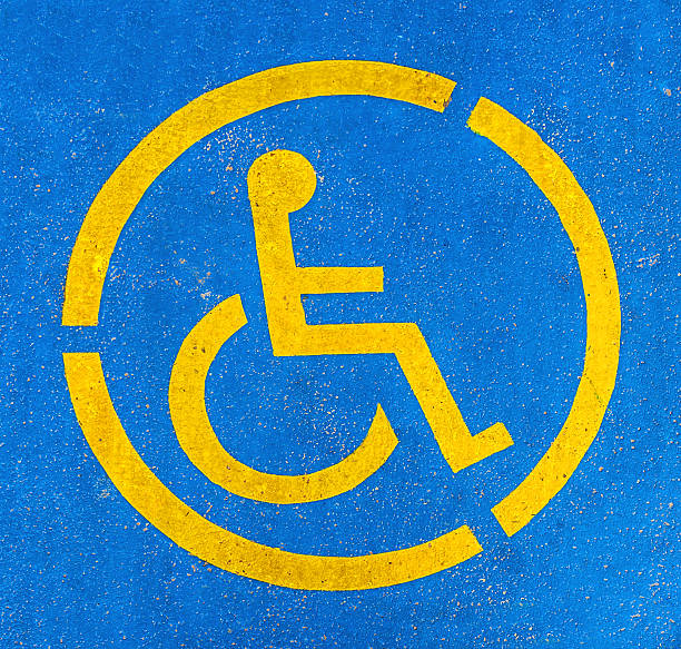 istock Blue and yellow handicap parking sign, persons with disabilities 636147122