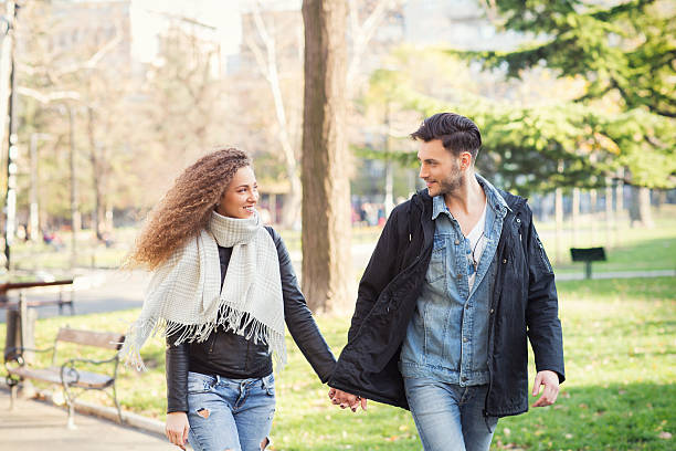 istock Couple walking in the park holding hands 636147552