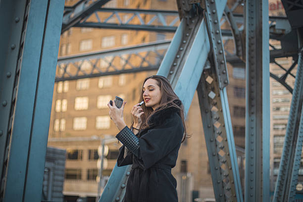 istock Girl putting lipstick 636147656