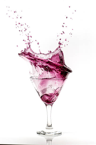 istock Splashing purple cocktail in martini glass 636147940
