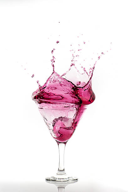 istock Splashing dark pink cocktail in a martini glass 636148788