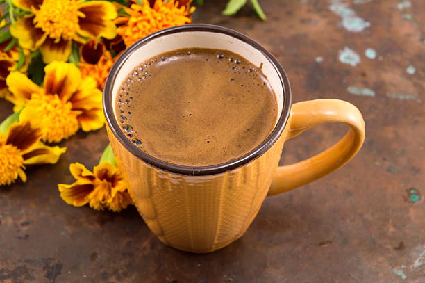 Cup of coffee in winter themed cup with flowers