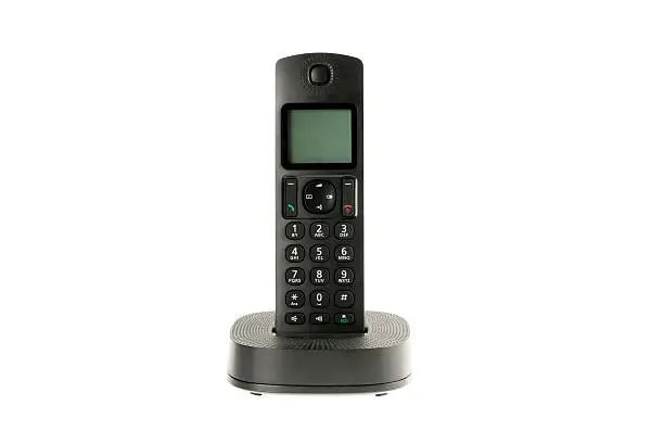 modern cordless dect phone with charging station isolated on white background