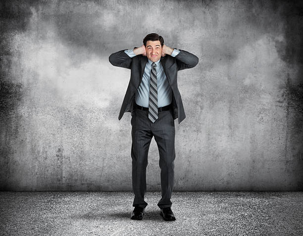 istock Businessman Covering Up His Ears With His Hands 636151866