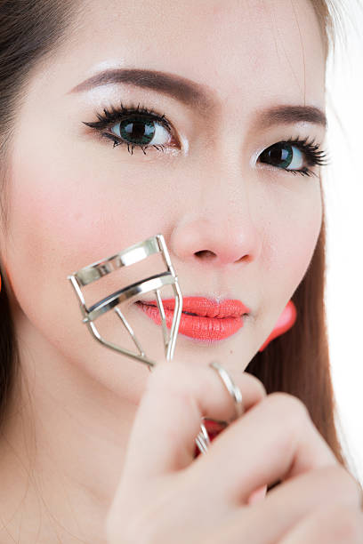 istock Asian woman making up in white background 636152040