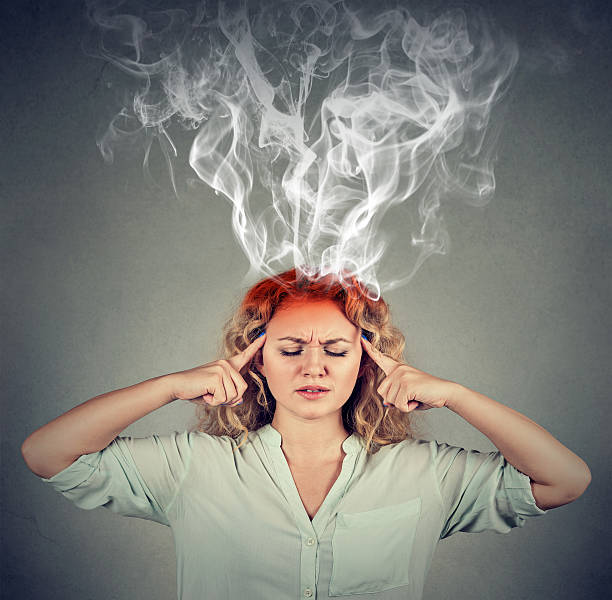 woman thinks very intensely having headache - heat effort emotional stress business imagens e fotografias de stock