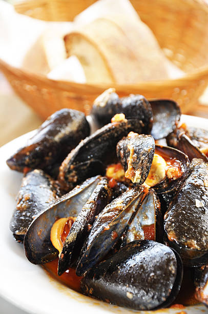 istock Mussels seafood with tomato sauce on white plate 636156948