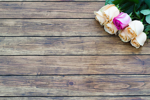 istock seven roses on a wooden background 636156950
