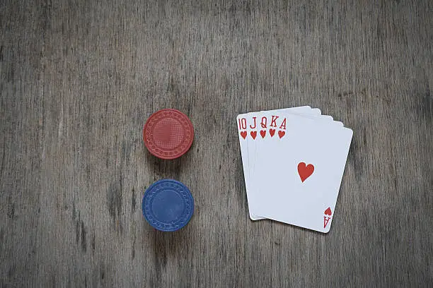 Chips and cards for poker on wooden table background. game abstract