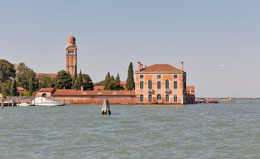 Lagoon and cityscape with Casino Degli Spiriti ancient building and Madonna Church bell tower in Venice, Italy.