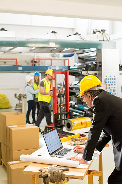 istock Quality inspectors reviewing production 636158882
