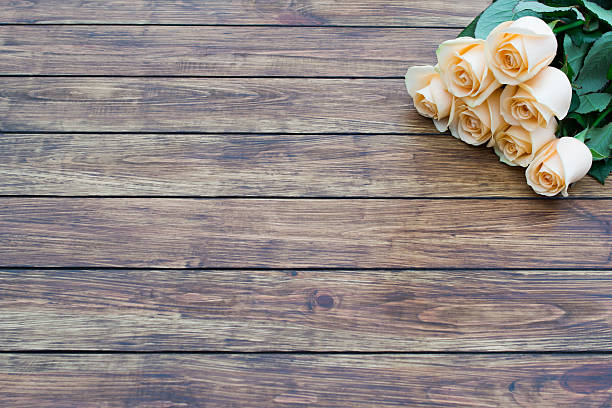 istock roses on a wooden background 636158906