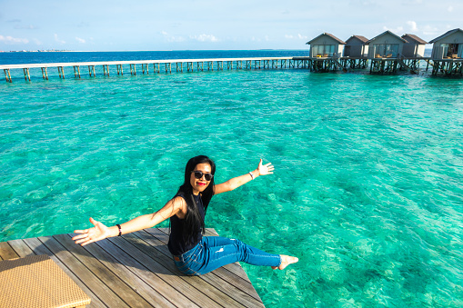 Portrait of Thai woman with overwater bungalows in Maldives