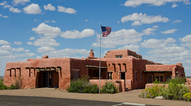 Painted Desert Inn at Petrified Forest National Park Petrified Forest, United States - September 3, 2016: The Painted Desert Inn was originally built in 1920 using petrified wood as the main construction product.  At that time it was known as the Stone Tree House, for obvious reasons, but in the late 1930's the building got a complete makeover by the Civilian Conservation Corps.  Since then its exterior has more of a Southwestern style of architecture with stucco walls and vegas used as support.  It now functions as a museum with the Petrified Forest National Park.  chinle formation stock pictures, royalty-free photos & images