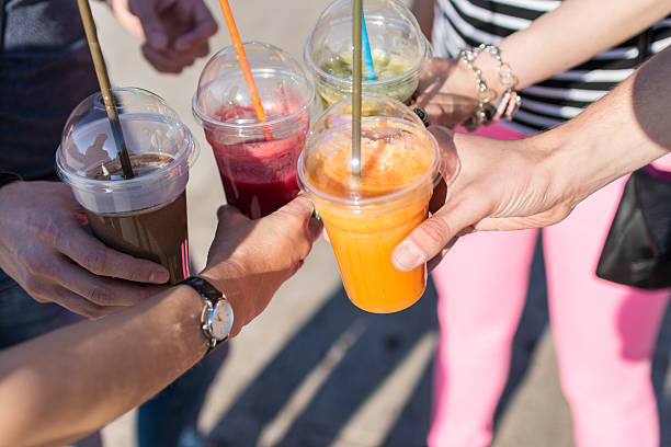 istock Friends having a toast holding fruit smoothies 636164462