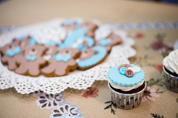 istock Beautiful blue cupcake and plate with teddy bears cookies biscuits 636164494