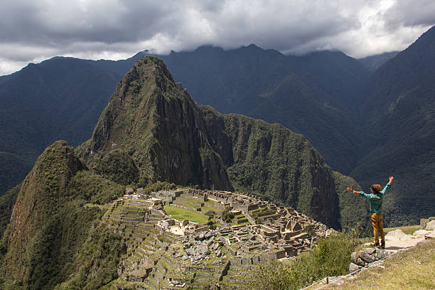 istock Man with bun admiring the Machu picchu ruins 636165598