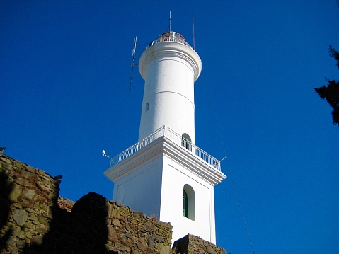 Lighthouse of Cabo de las Huertas in Alicante, aerial view on a bright day and with the sea combed by the strong west wind and with a strong blue color of the sea.