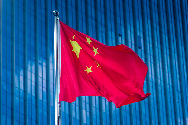 istock Chinese flag flying frontof  futuristic skyscraper 636169664