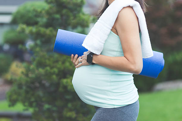 ethnische schwangere mutter wartet darauf, yoga draußen zu tun - human pregnancy exercising relaxation exercise sport stock-fotos und bilder