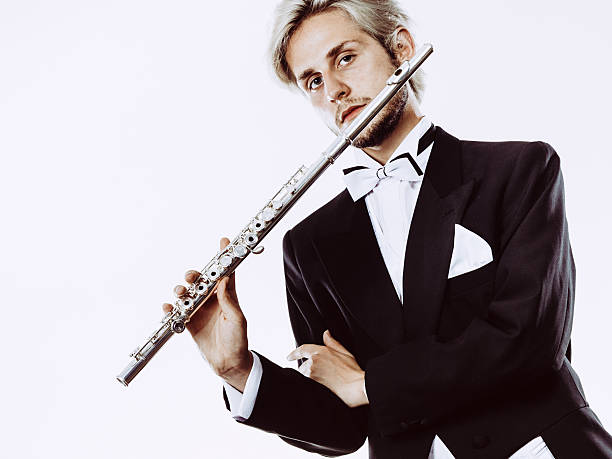 istock Male flutist wearing tailcoat holds flute 636169968