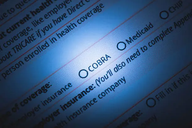 A stock photo of a US Healthcare / Health insurance application form. Photographed using Canon EOS 5DSR at 50mp. Focused on the words "COBRA". Perfect for designs or articles about healthcare, health insurance, Obamacare or the affordable health care act.