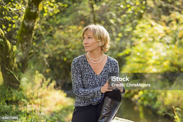 Beautiful Mid 30s Woman Thoughtfully Looking Away Holding Cup Stock Photo - Download Image Now