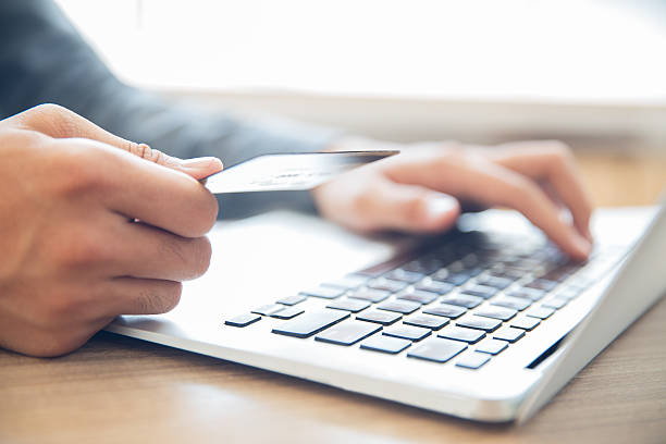 istock Hands holding credit card and typing on laptop 636172866