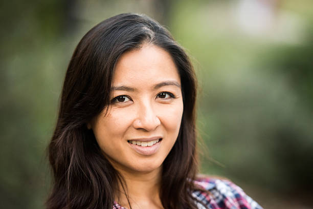 istock Smiling asian woman looking at the camera 636173070