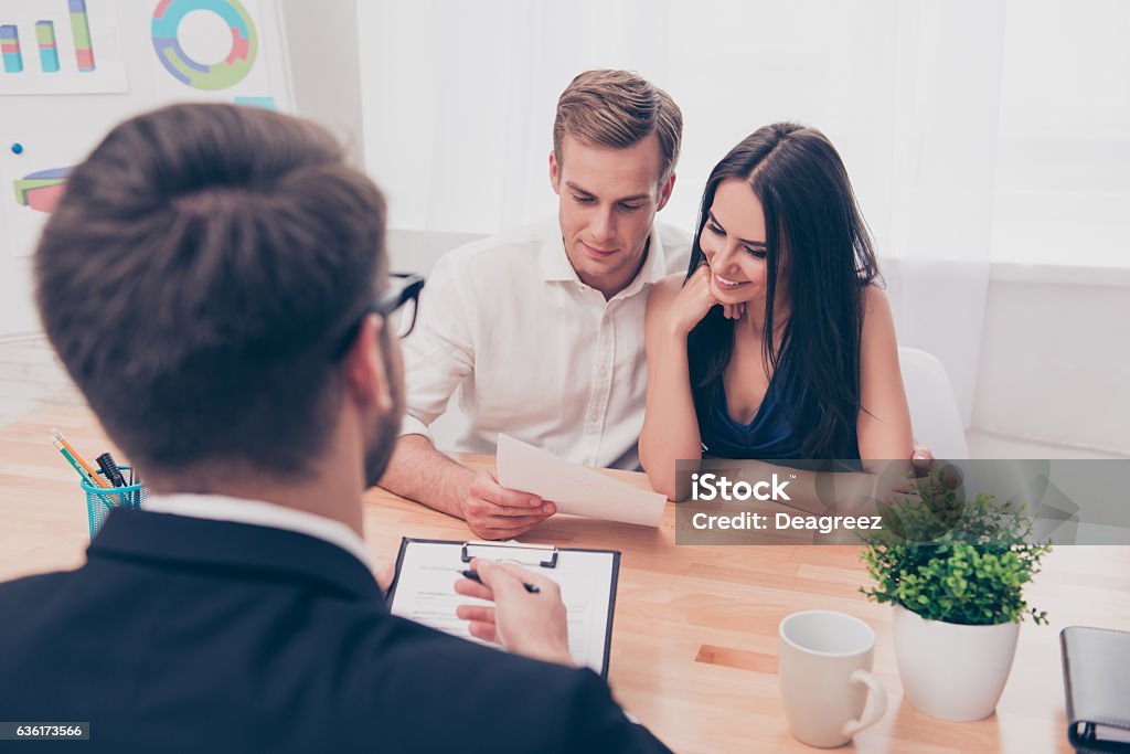 Real estate agent helping young family to buy flat Financial Advisor Stock Photo